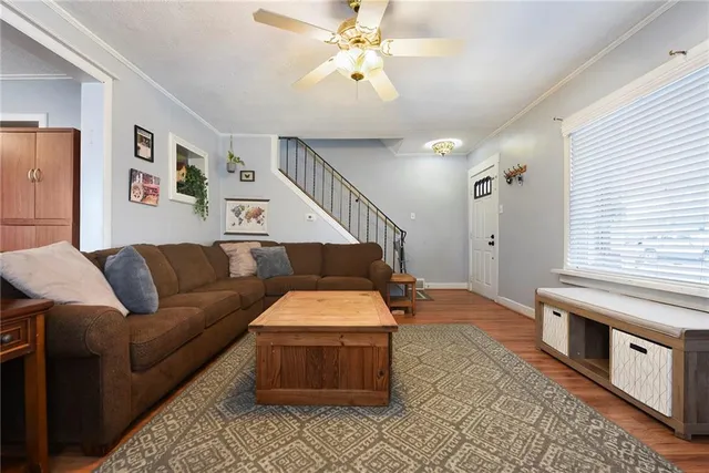 a living room with furniture and a chandelier