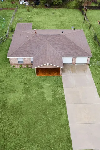a aerial view of a house with backyard and a garden