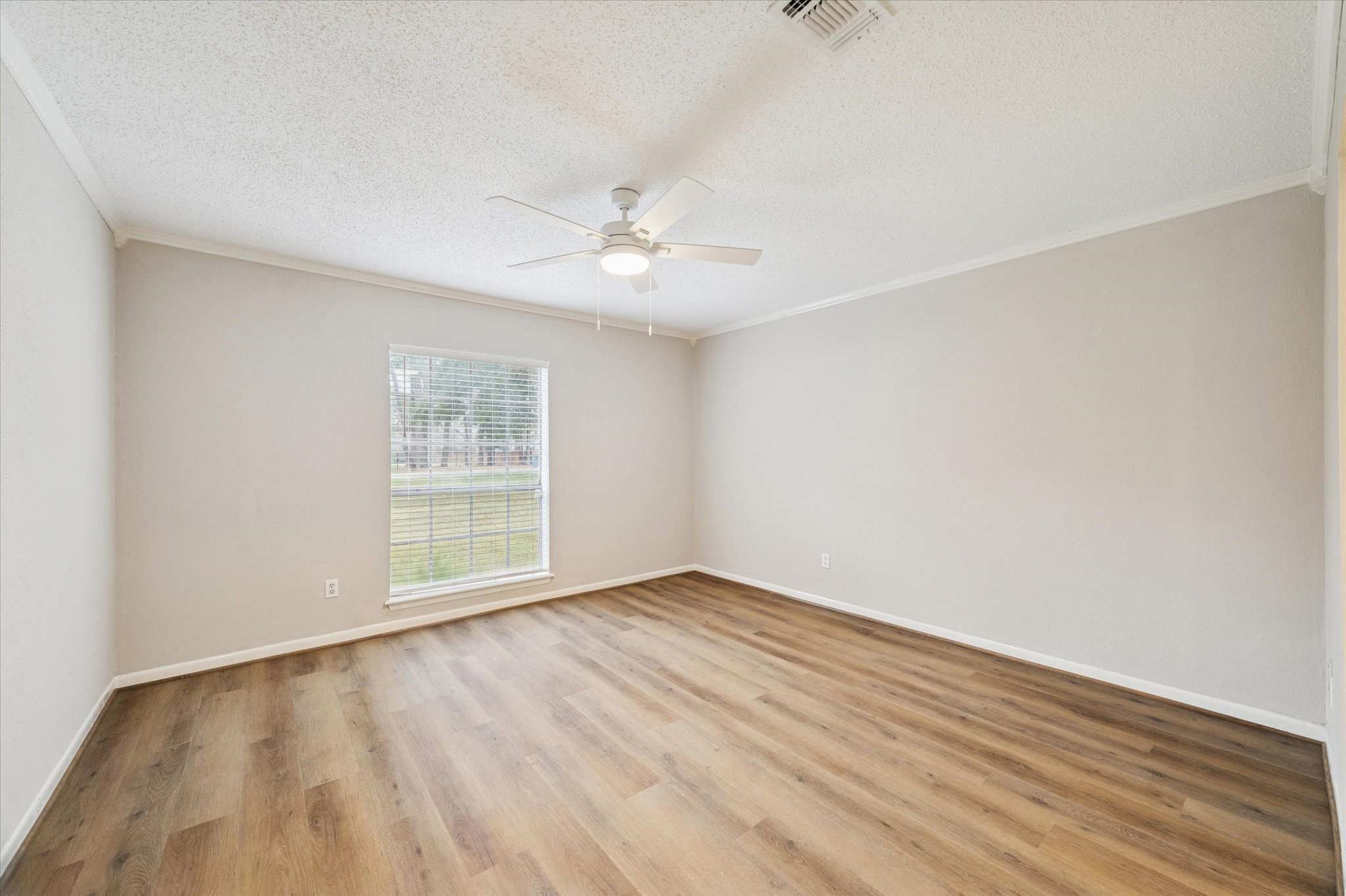 14722 Brown Road Tomball, TX 77377 - Photo 11 of 21 Generously sized primary bedroom with laminate flooring and fresh interior paint.