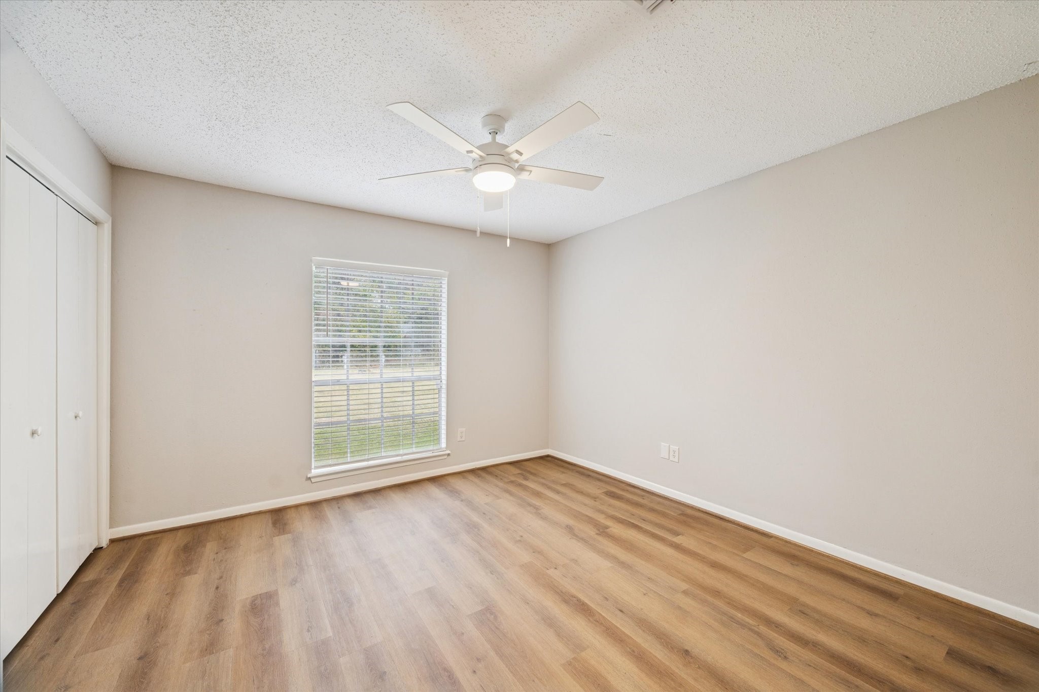 14722 Brown Road Tomball, TX 77377 - Photo 15 of 21 Secondary bedroom with laminate flooring and fresh paint.
