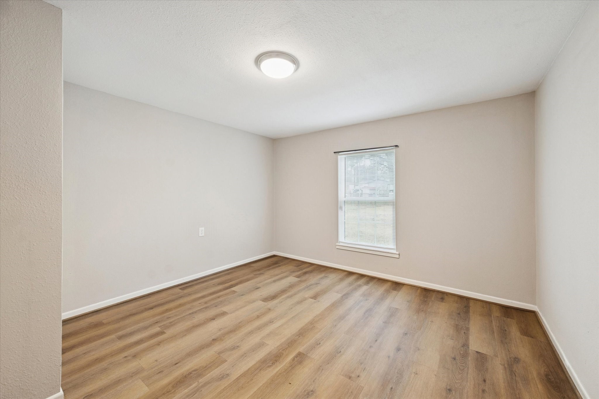 14722 Brown Road Tomball, TX 77377 - Photo 18 of 21 Bedroom four with laminate flooring and fresh paint. Can also be used as a flex room or office.