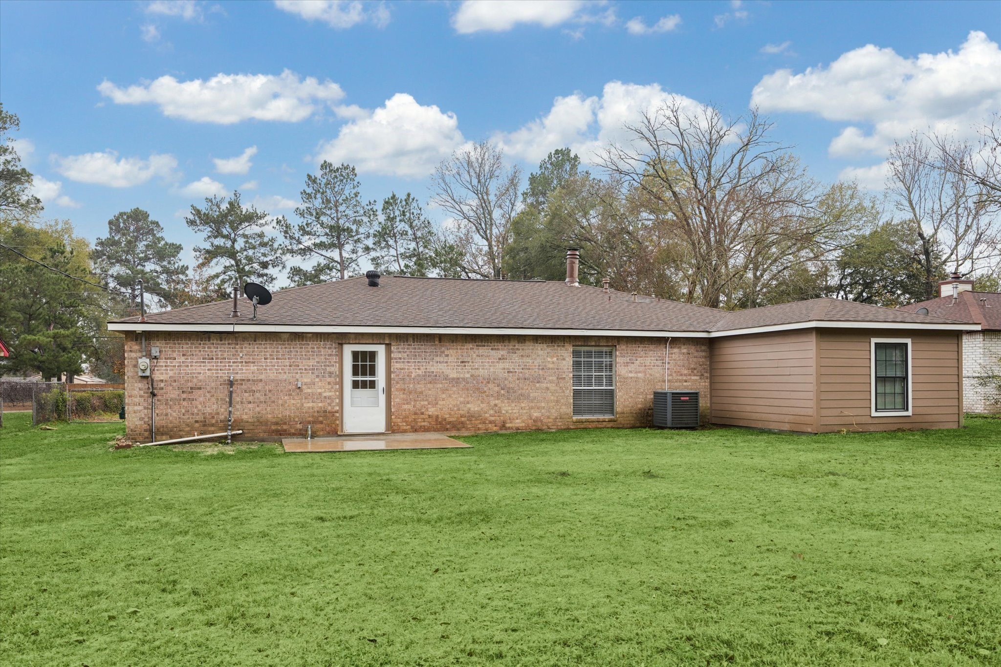 14722 Brown Road Tomball, TX 77377 - Photo 21 of 21 Rear view featuring a small patio and a large, fully fenced backyard.