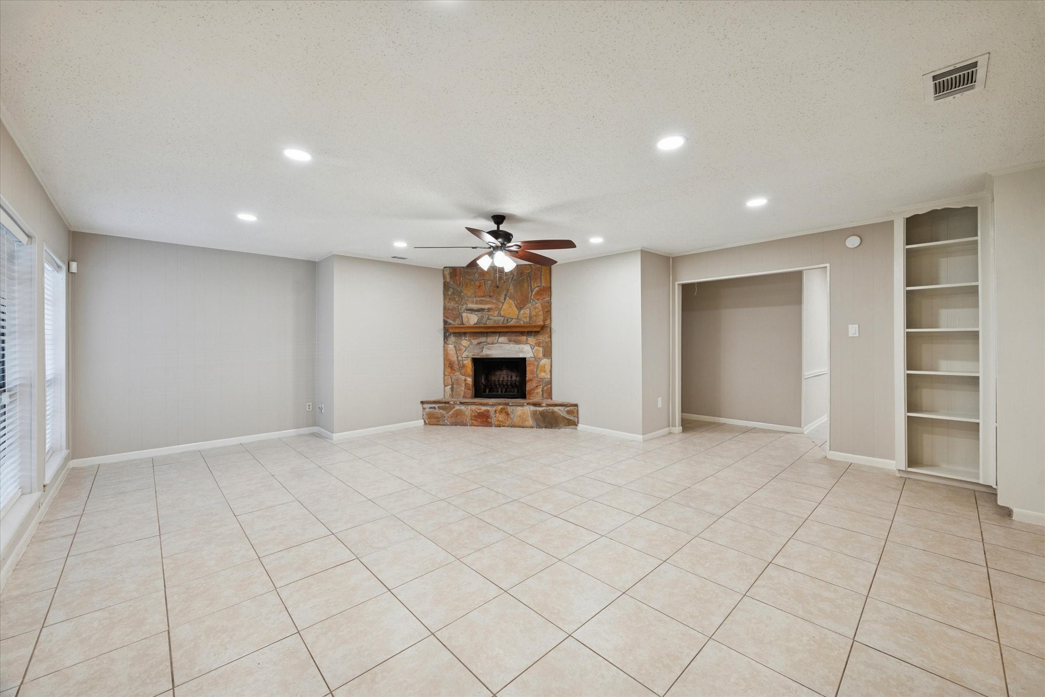 14722 Brown Road Tomball, TX 77377 - Photo 4 of 21 Bright main living area featuring tile floors, fresh paint, and a cozy fireplace.