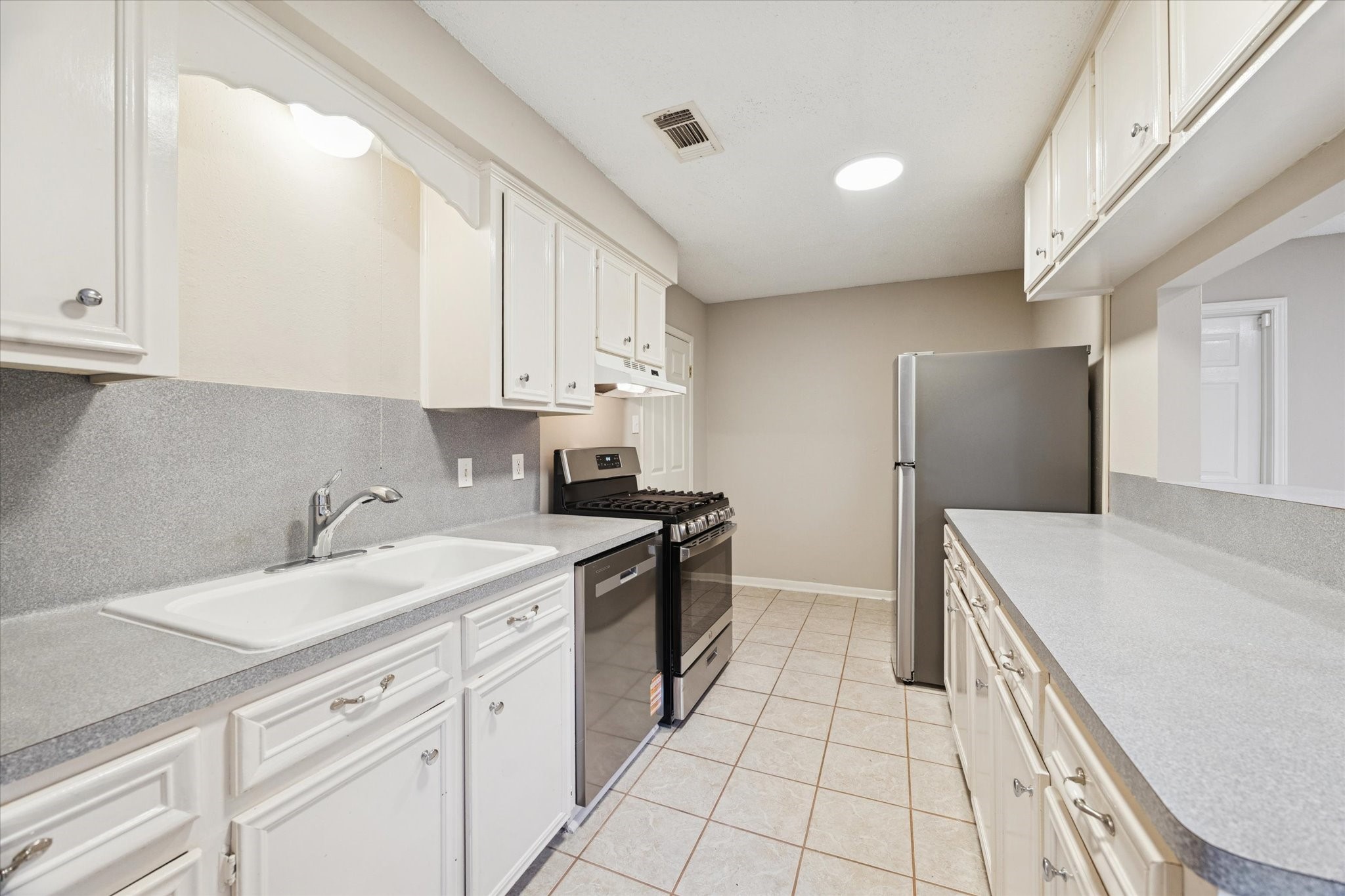 14722 Brown Road Tomball, TX 77377 - Photo 9 of 21 Galley-style kitchen with abundant counter space and new stainless steel appliances.