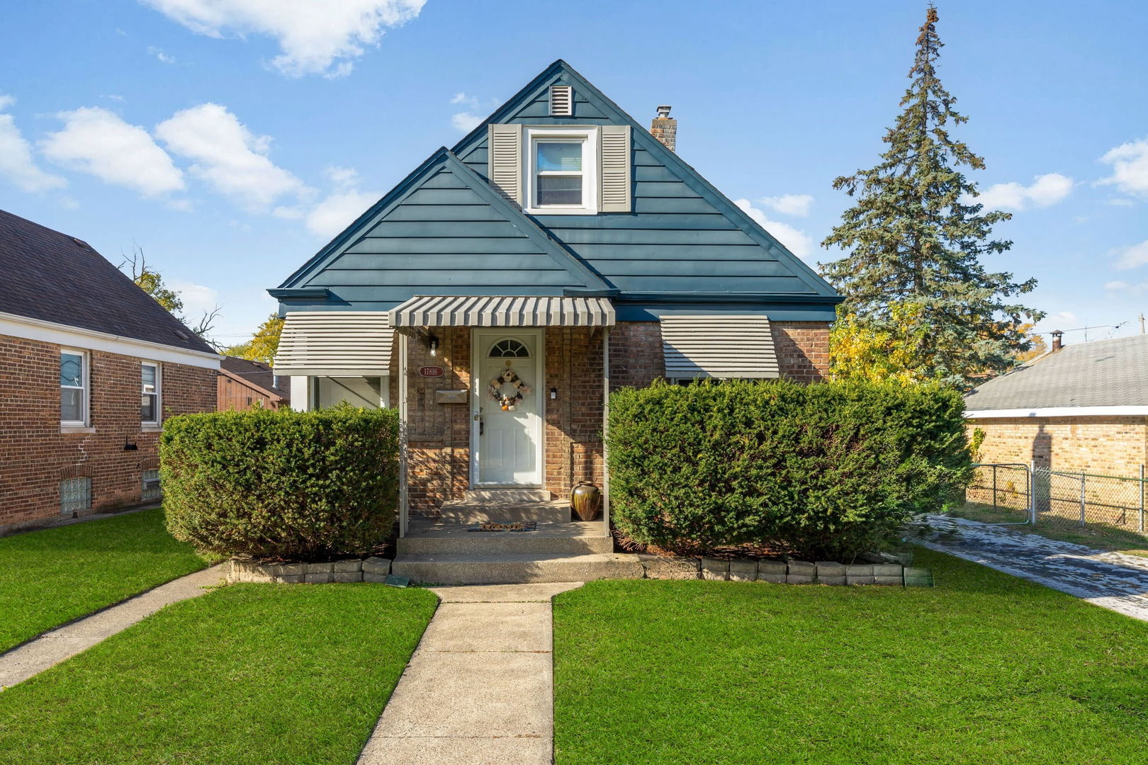 17816 Commercial Avenue Lansing, IL 60438 - Photo 1 of 17 a front view of a house with a garden