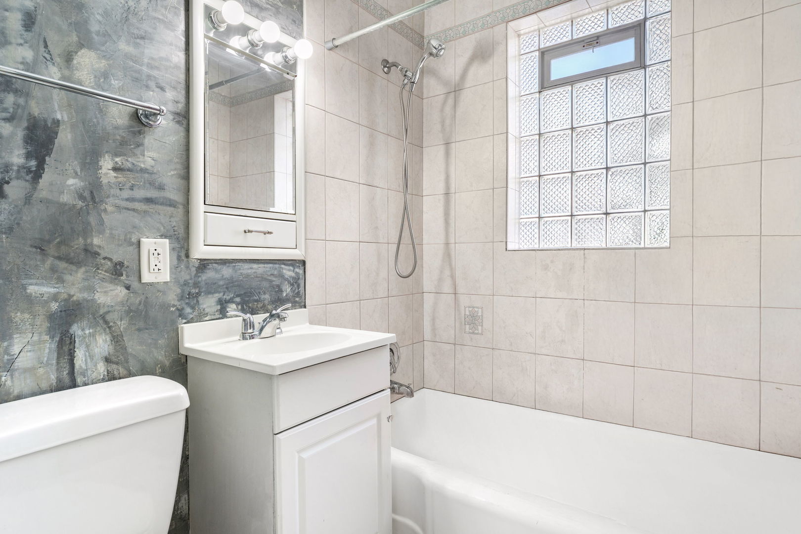 17816 Commercial Avenue Lansing, IL 60438 - Photo 9 of 17 a bathroom with a sink a toilet and shower