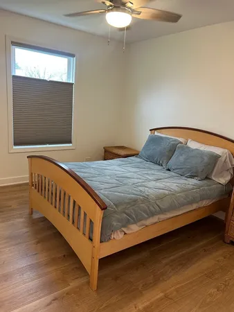 a bedroom with a bed and window