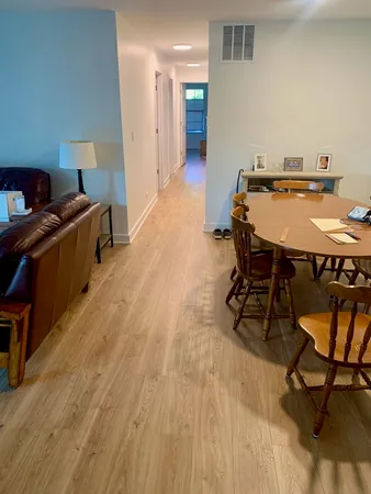 a view of a workspace with furniture and a wooden floor