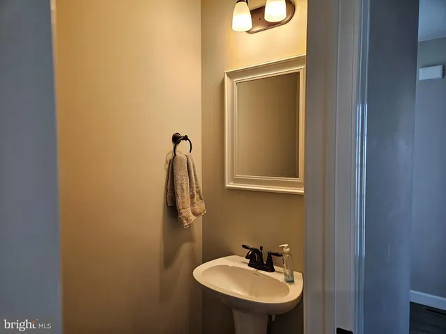 a bathroom with a sink and mirror