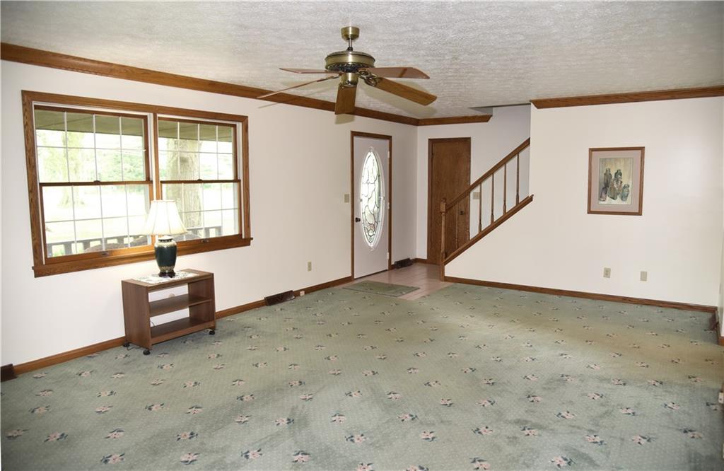  The living room has Stunning oak trim and crown molding 