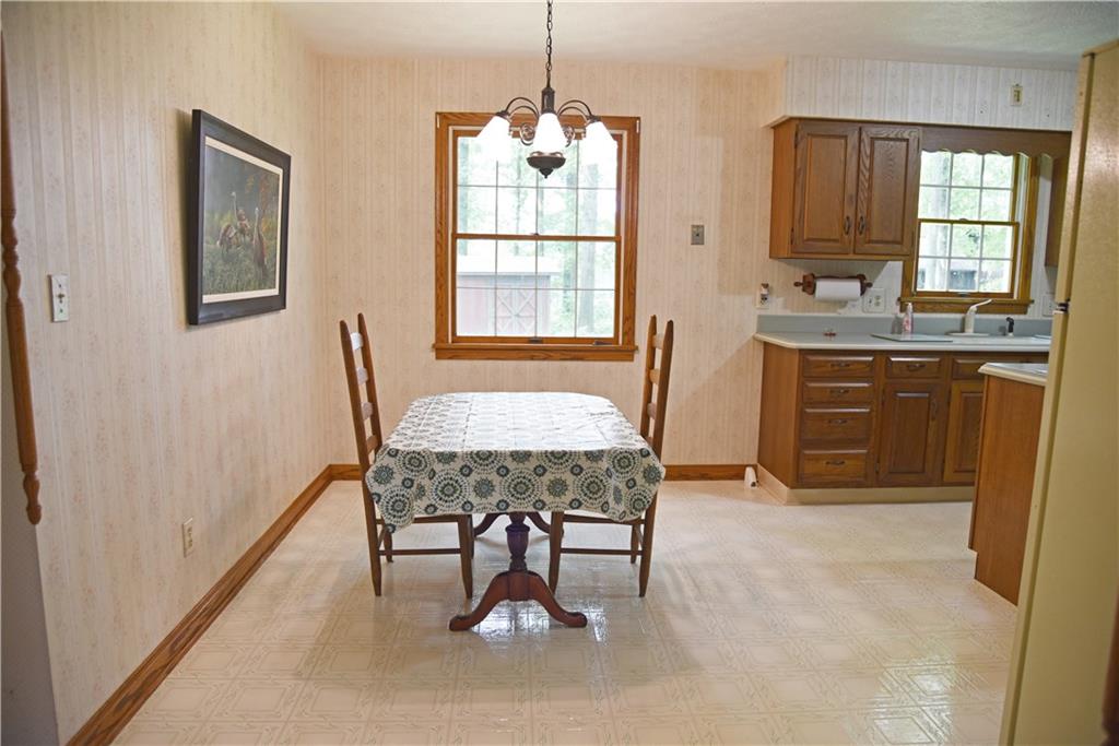 Spacious eat in kitchen with oak trim, oak cabinets and solid surface countertops.