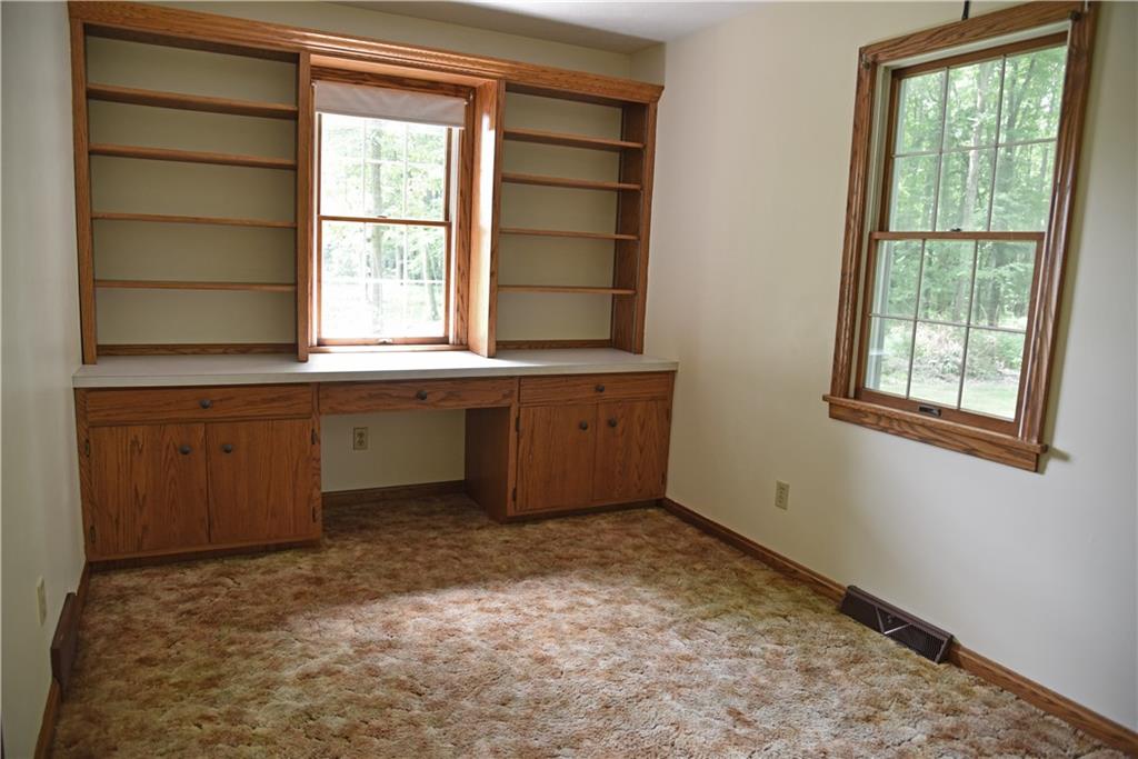 1982 South Keel Ridge Road Hermitage, PA 16148 - Photo 10 of 22 main floor office with built in desk and bookcases.