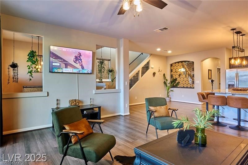 6302 Jackson Spring Road Las Vegas, NV 89118 - Photo 5 of 23 An inviting open-concept living space features stylish wood flooring and a kitchen with an eat-in island.