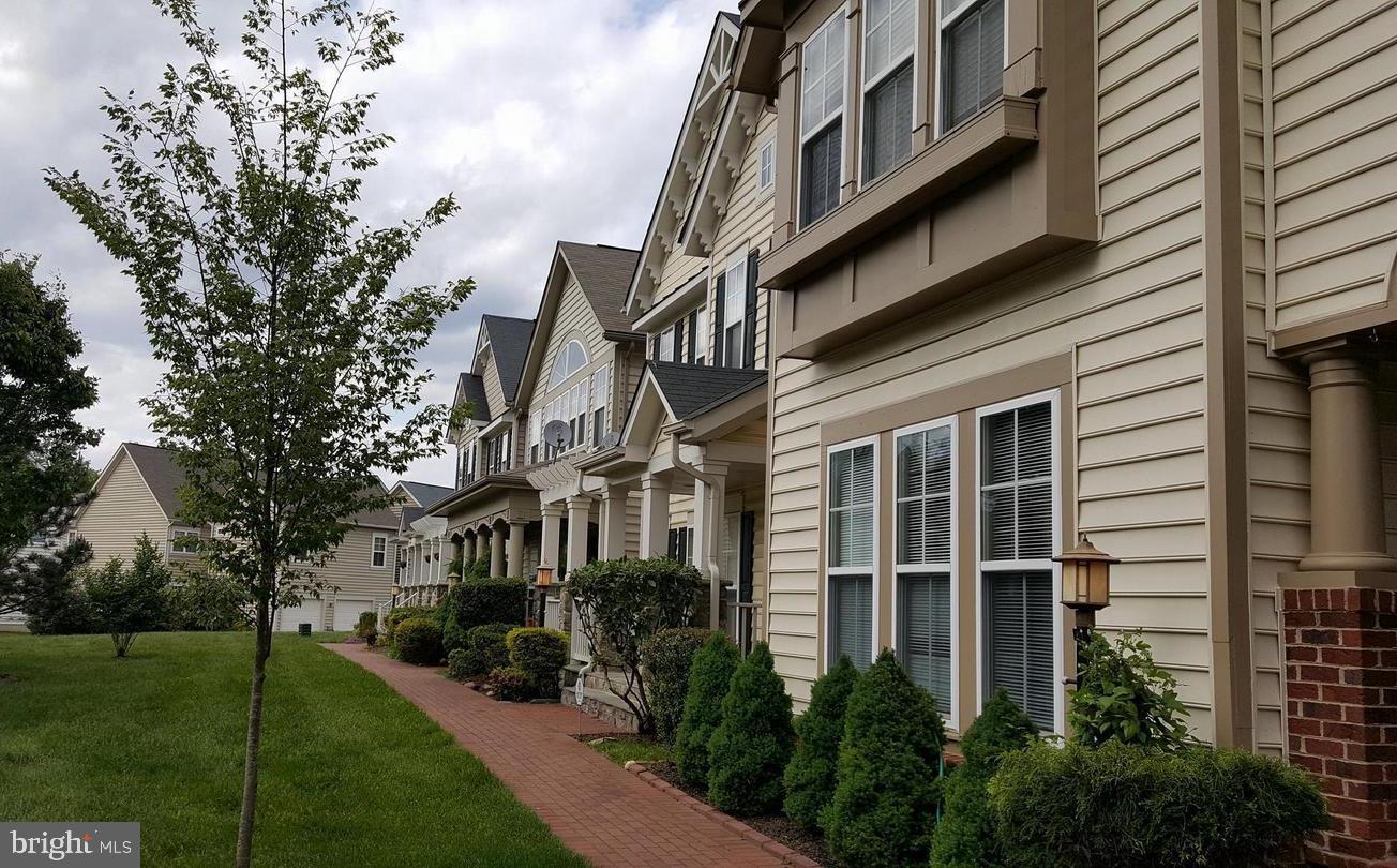 9163 Stone Garden Lorton, VA 22079 - Photo 1 of 25 a view of a building with a yard