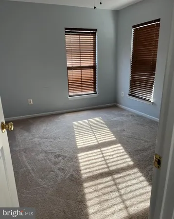 a view of an empty room with windows