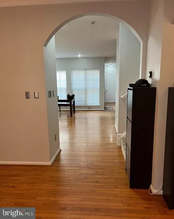 a view of empty room with wooden floor and chair