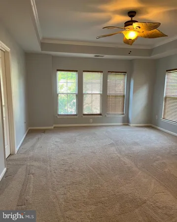 a view of an empty room with window and cabinet