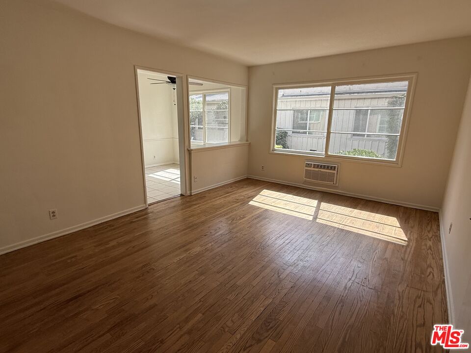 5719 Tilden Avenue, Unit A Sherman Oaks, CA 91401 - Photo 2 of 11 an empty room with wooden floor and windows