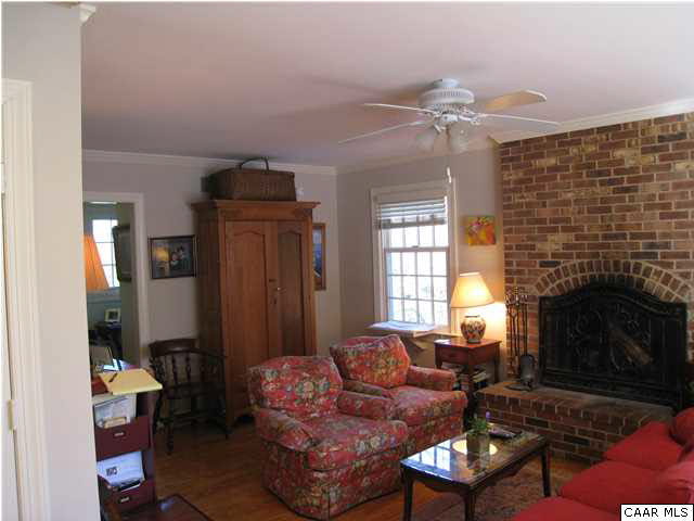 1828 Westview Road Charlottesville, VA 22903 - Photo 3 of 22 a living room with furniture a fireplace and a chandelier