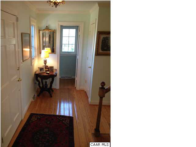 1828 Westview Road Charlottesville, VA 22903 - Photo 8 of 22 a view of a hallway with wooden floor and a living room