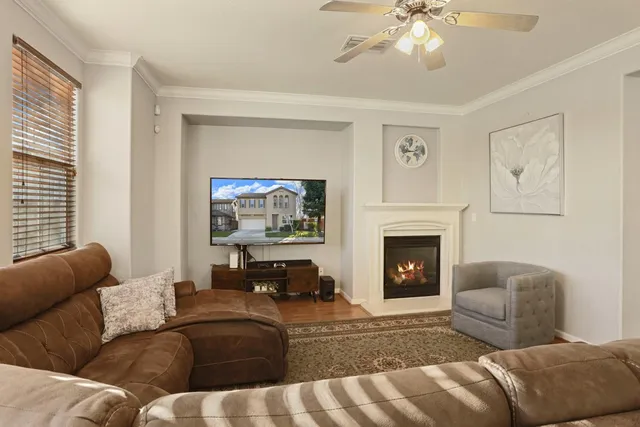 a living room with fireplace furniture and a large window