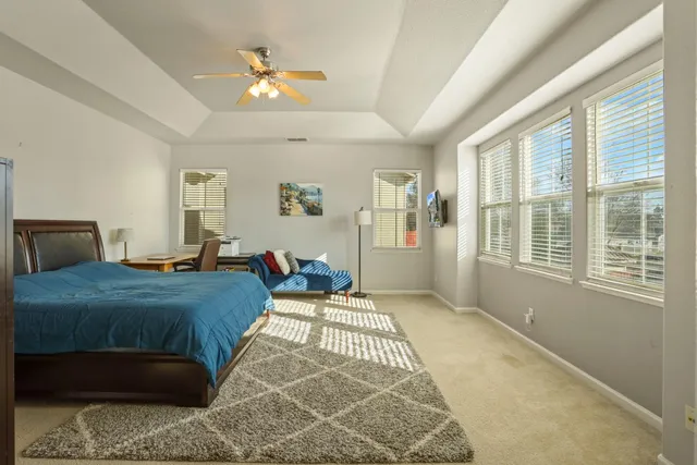 a bedroom with a bed and a chandelier