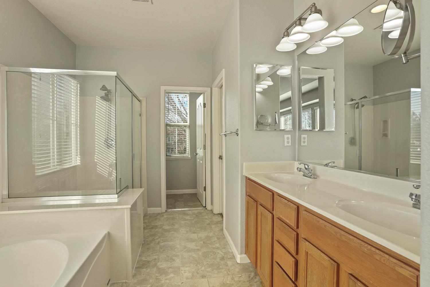 3144 Sweet Lilac Way Stockton, CA 95209 - Photo 38 of 76 a bathroom with a sink a vanity and a mirror