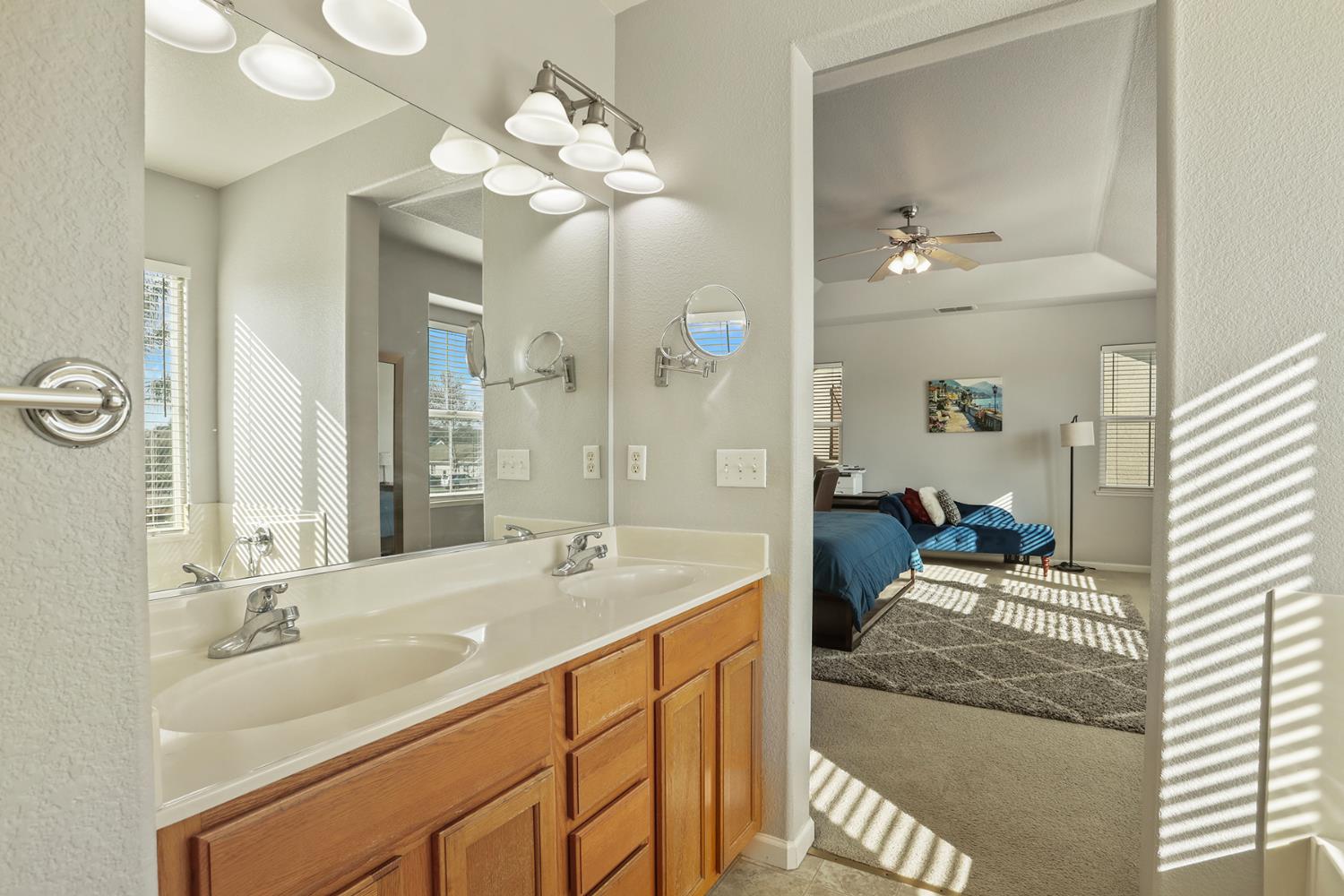 3144 Sweet Lilac Way Stockton, CA 95209 - Photo 39 of 76 a en suite bathroom with a double vanity sink and a mirror