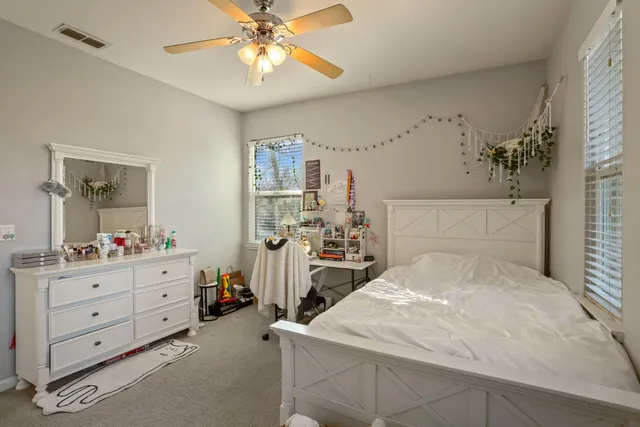 a bathroom with a sink a toilet and shower curtain