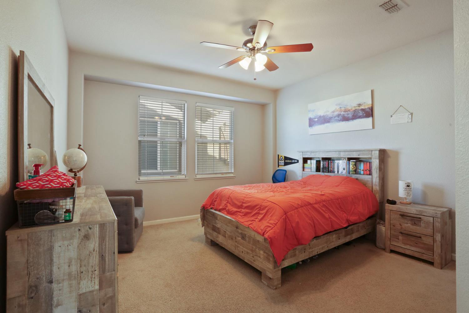 3144 Sweet Lilac Way Stockton, CA 95209 - Photo 46 of 76 a bedroom with a bed and a chandelier