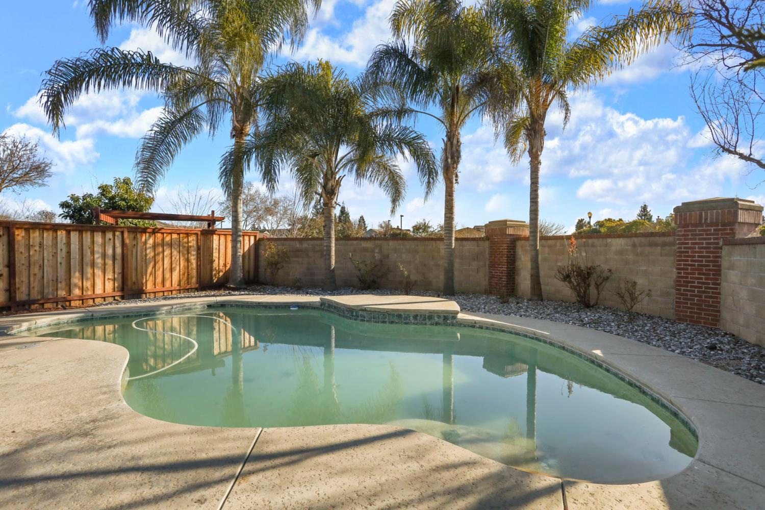 3144 Sweet Lilac Way Stockton, CA 95209 - Photo 53 of 76 a view of a swimming pool with a lounge chair