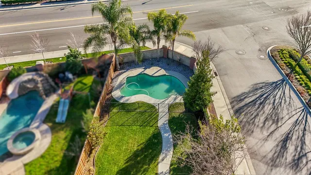 a view of swimming pool with a garden and seating area