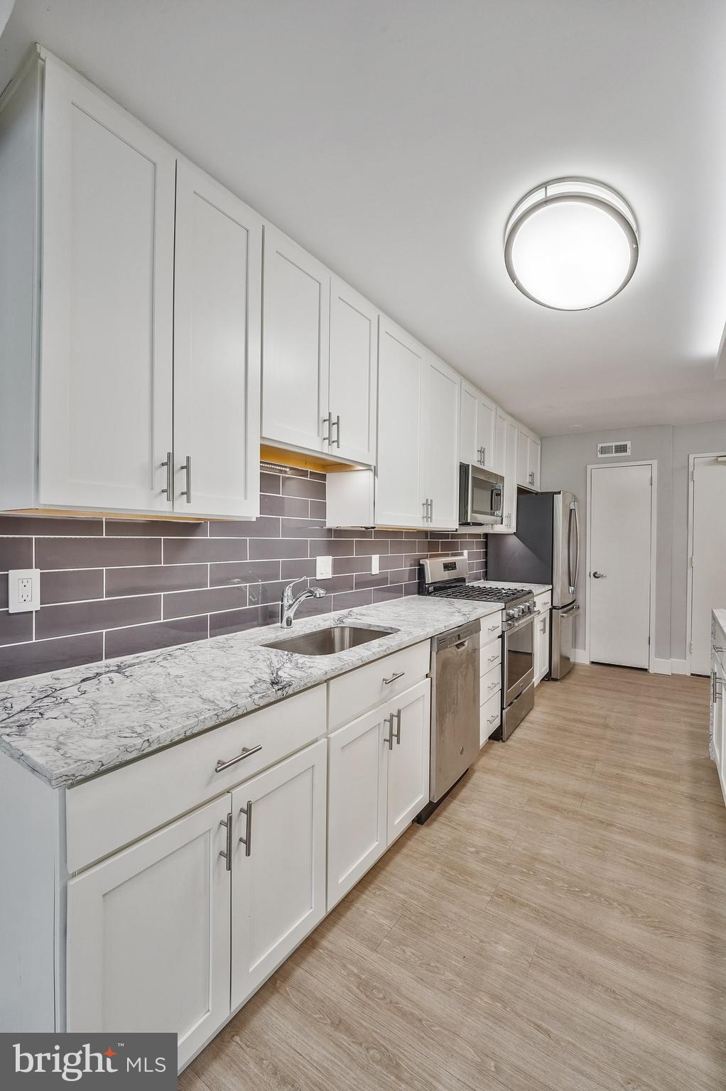 5101 River Road, Unit 618 Bethesda, MD 20816 - Photo 11 of 46 a kitchen with stainless steel appliances granite countertop a sink and cabinets