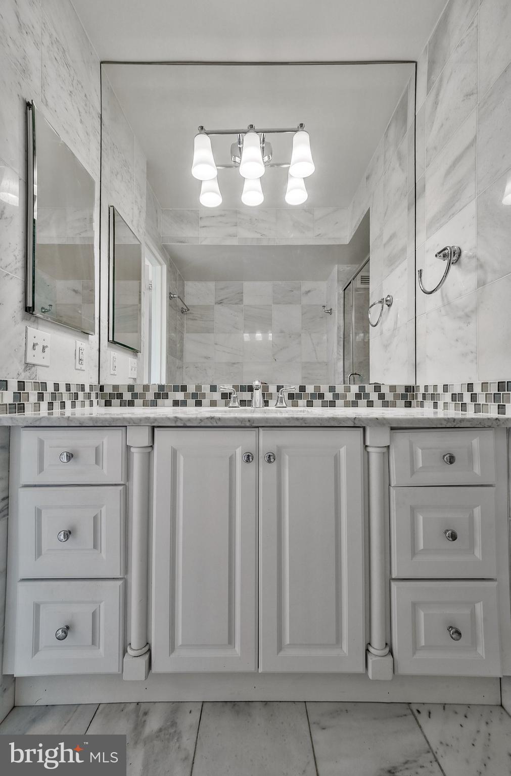 5101 River Road, Unit 618 Bethesda, MD 20816 - Photo 21 of 46 a bathroom with a sink and a mirror