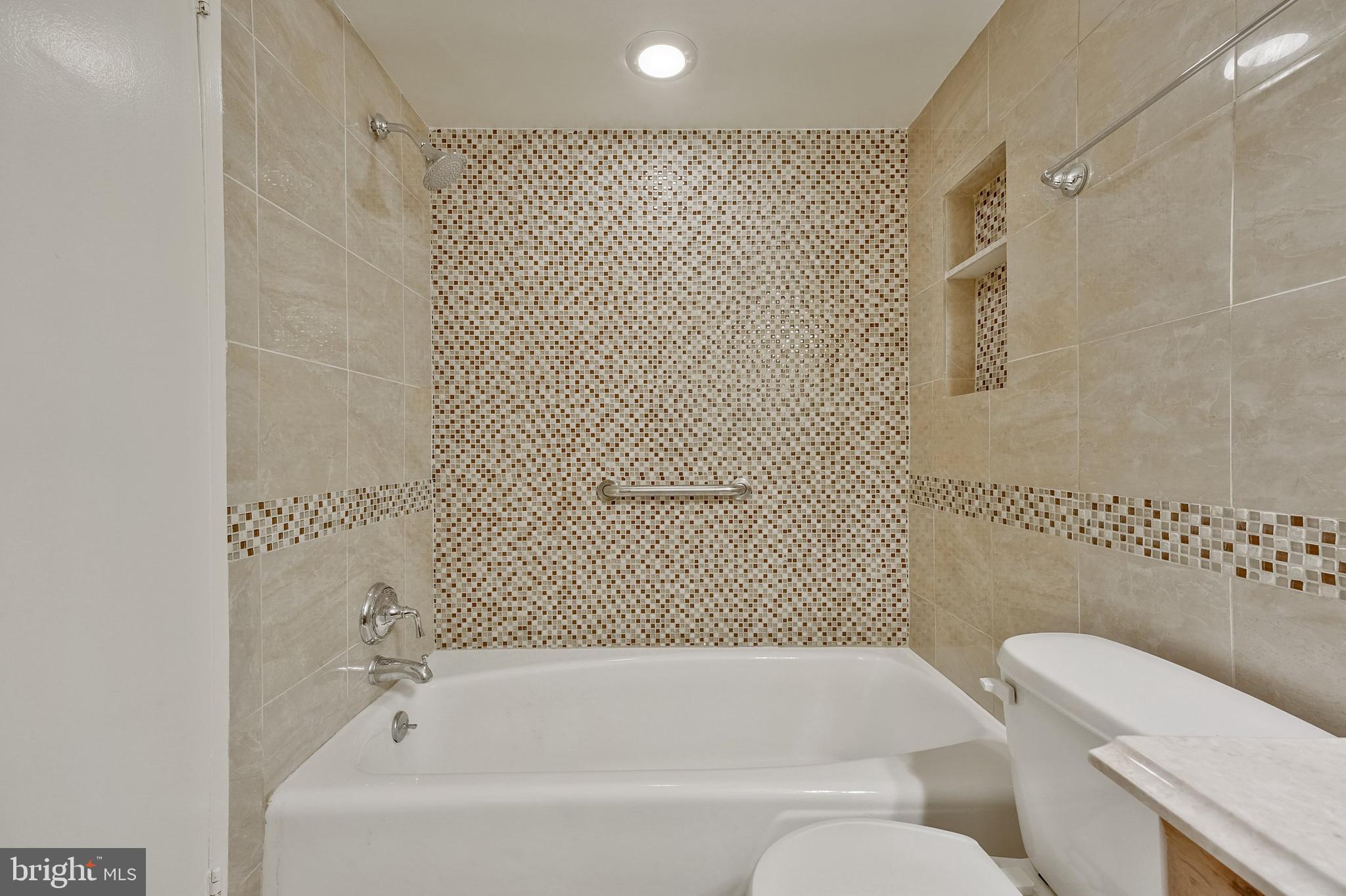 5101 River Road, Unit 618 Bethesda, MD 20816 - Photo 28 of 46 a bathroom with a bathtub and shower