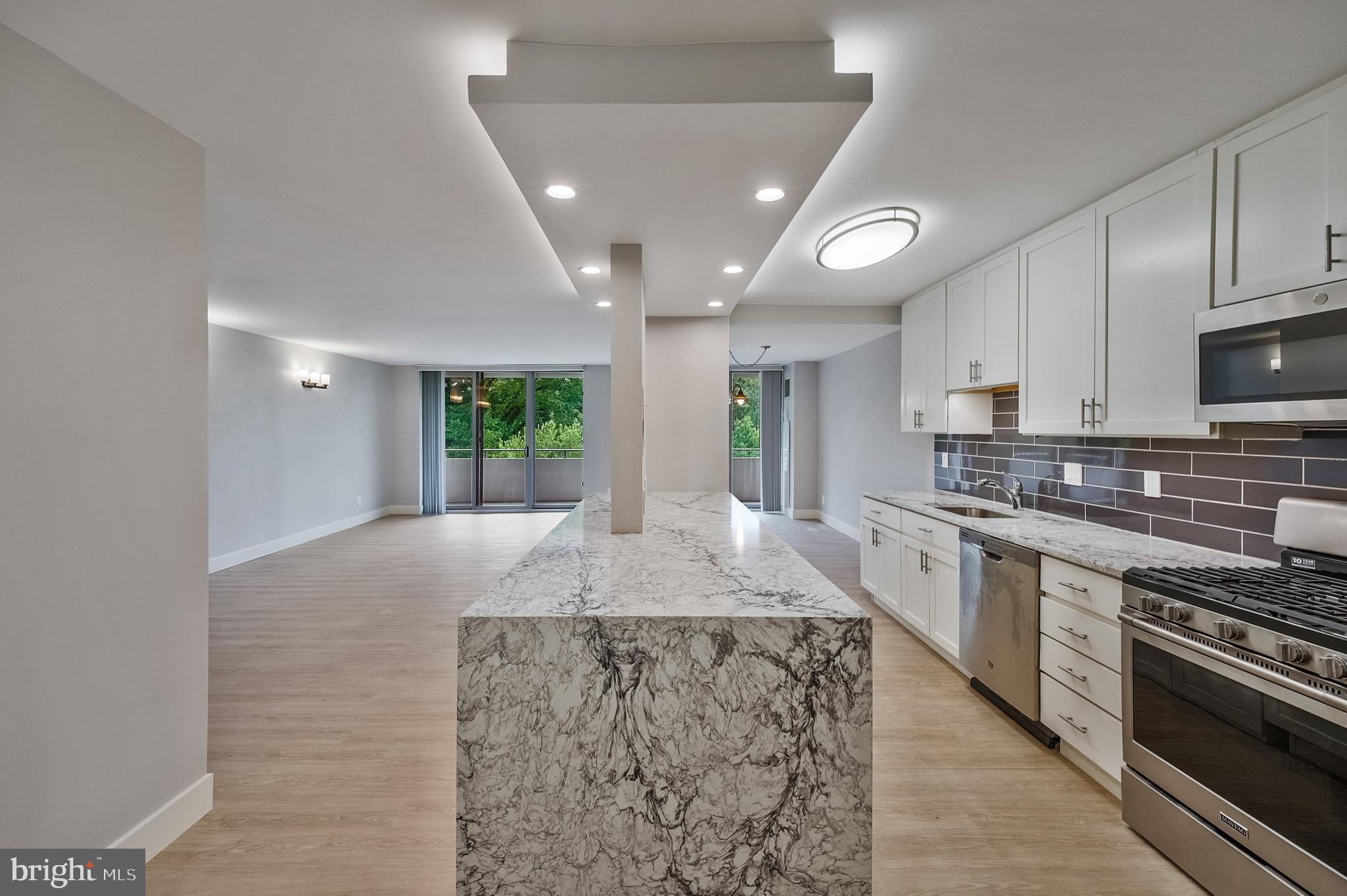 5101 River Road, Unit 618 Bethesda, MD 20816 - Photo 4 of 46 a large kitchen with granite countertop a stove and a sink
