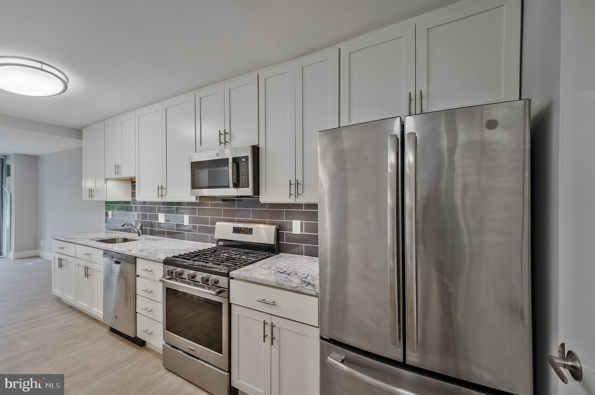 5101 River Road, Unit 618 Bethesda, MD 20816 - Photo 5 of 46 a kitchen with stainless steel appliances a refrigerator stove and microwave