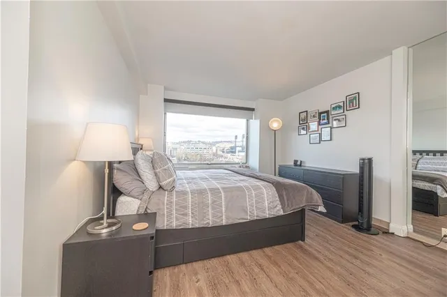 a bed sitting in a bedroom next to a lamp