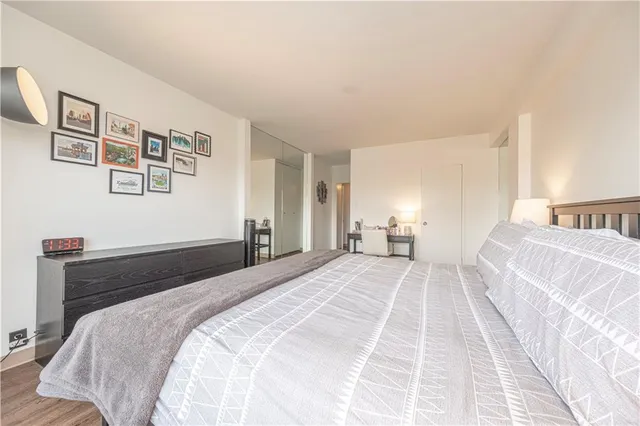 a bedroom with a bed and a lamp