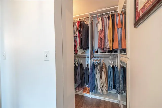 a view of walk in closet with clothes