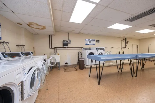 a kitchen with stainless steel appliances a sink a stove and a refrigerator with wooden floor