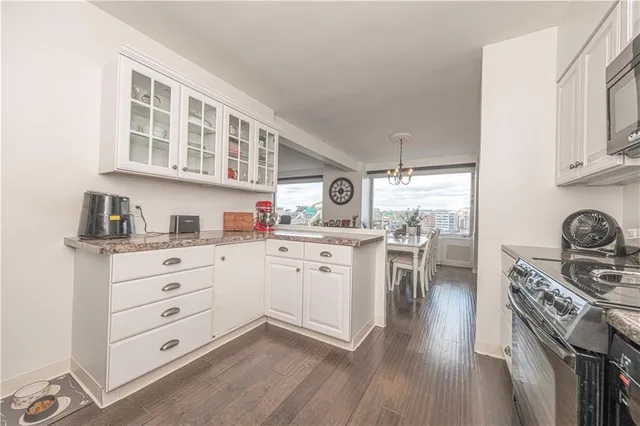 a kitchen with white cabinets and appliances