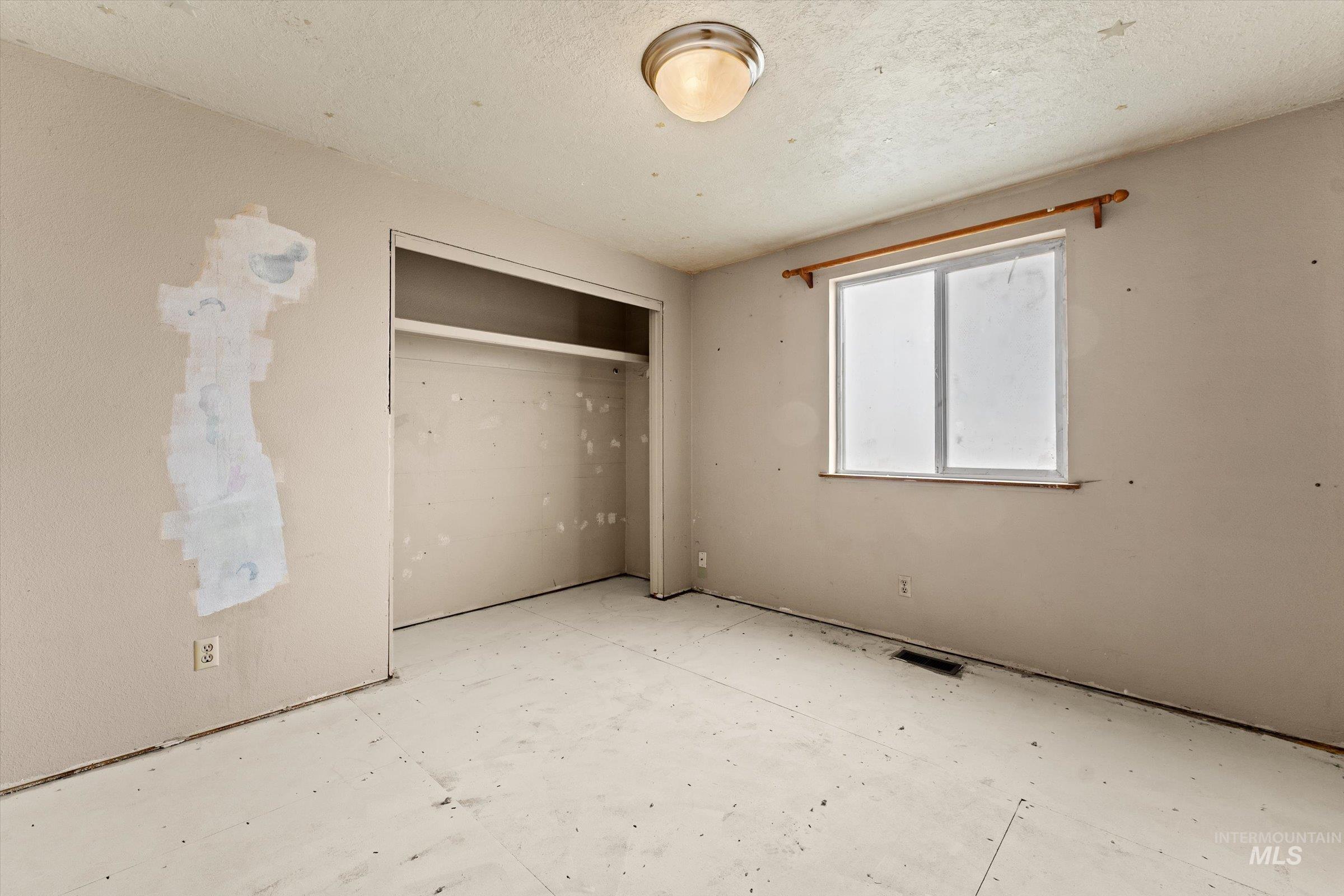 6267 Deer Flat Road Nampa, ID 83686 - Photo 15 of 50 Unfurnished bedroom featuring a closet and a textured ceiling