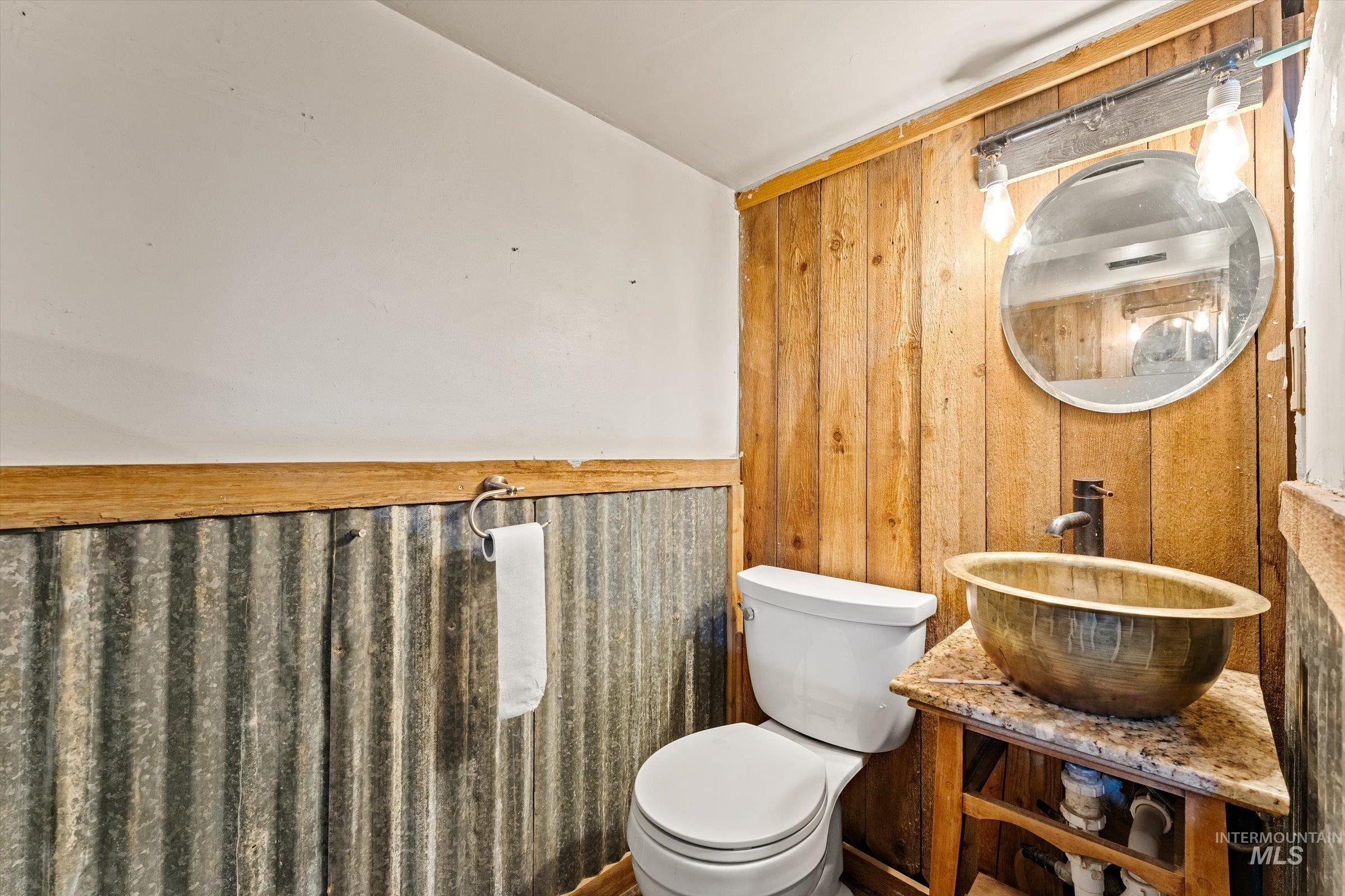 6267 Deer Flat Road Nampa, ID 83686 - Photo 19 of 50 Bathroom with wood walls and vanity