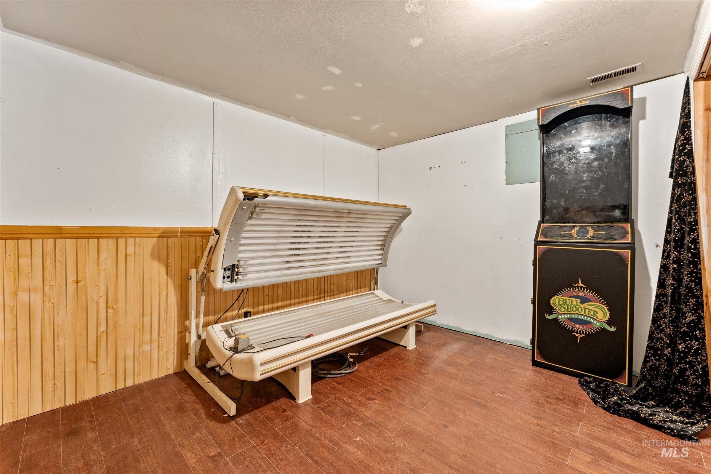 6267 Deer Flat Road Nampa, ID 83686 - Photo 20 of 50 Miscellaneous room featuring a tanning bed, wainscoting, and wood walls