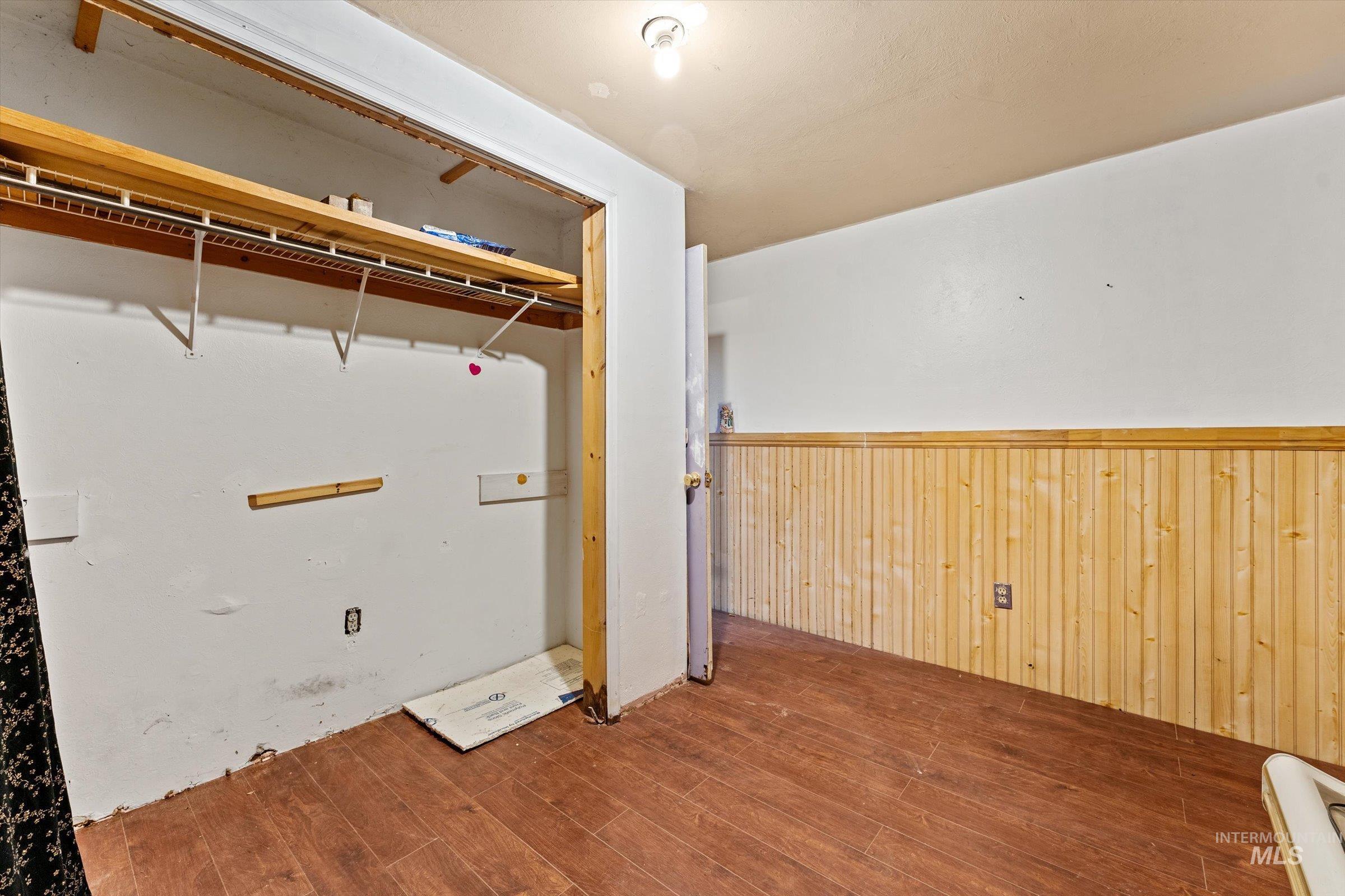 6267 Deer Flat Road Nampa, ID 83686 - Photo 21 of 50 Laundry room with wooden walls, wood finished floors, and a wainscoted wall