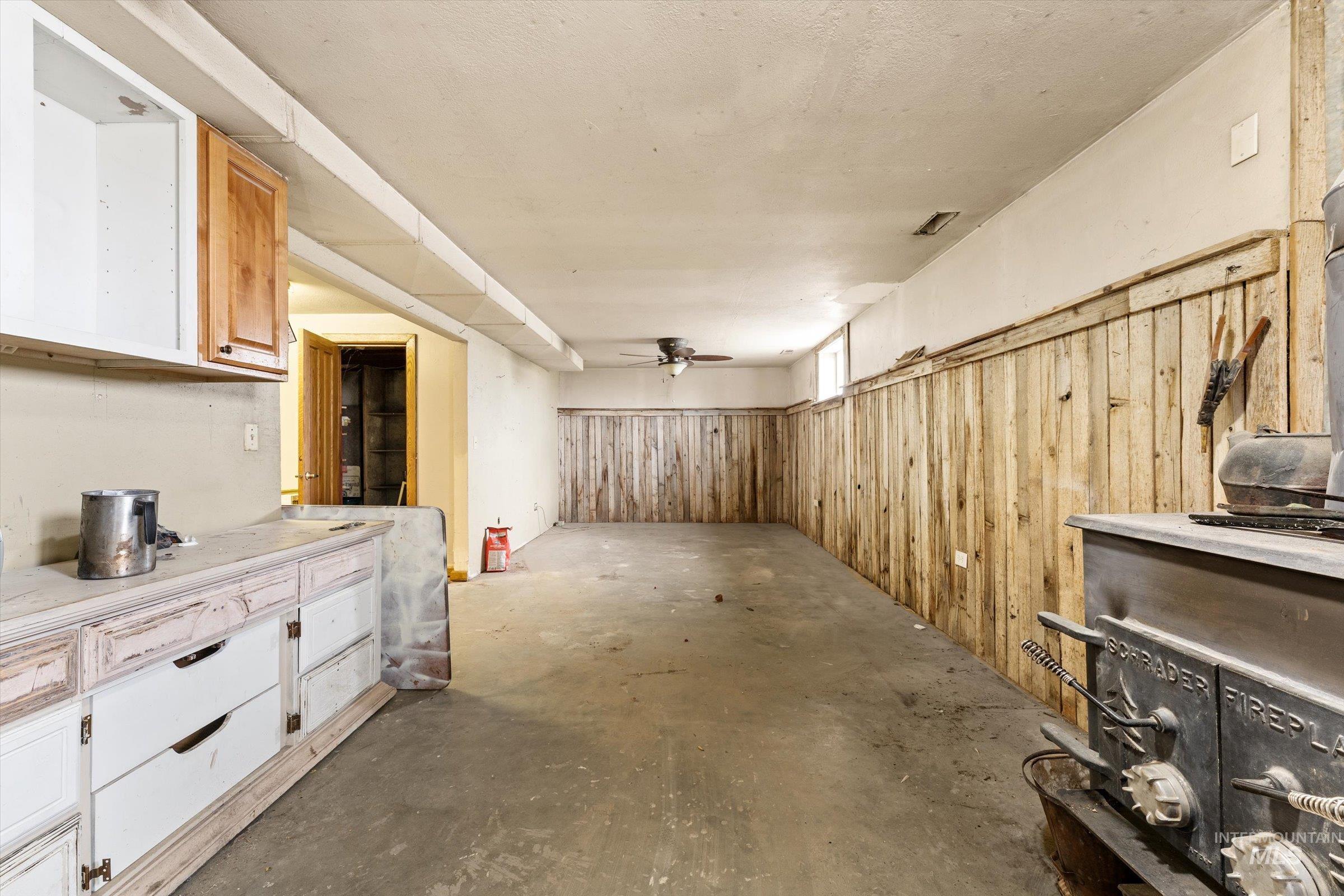 6267 Deer Flat Road Nampa, ID 83686 - Photo 28 of 50 Basement featuring wood walls, a ceiling fan, and wainscoting