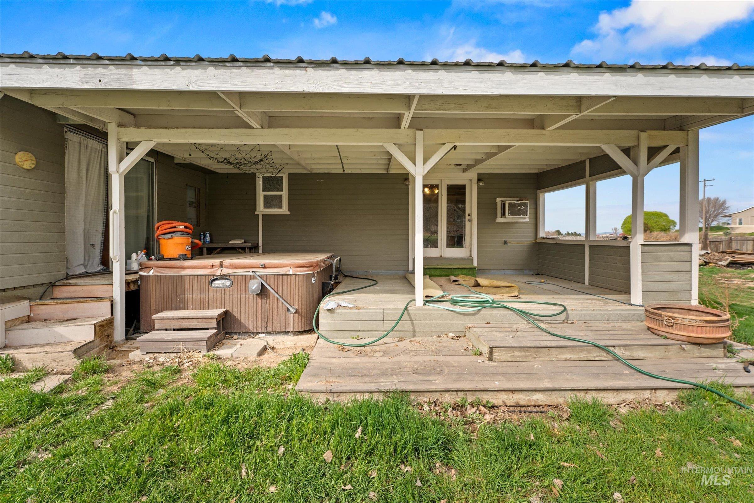 6267 Deer Flat Road Nampa, ID 83686 - Photo 32 of 50 View of patio featuring a hot tub and a wooden deck