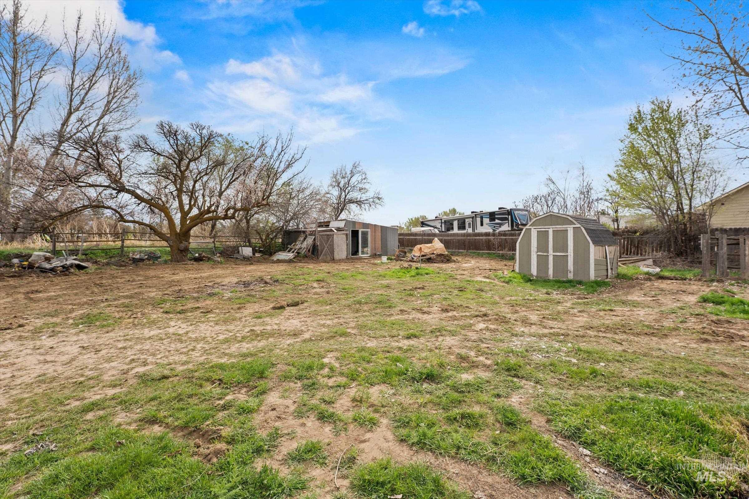 6267 Deer Flat Road Nampa, ID 83686 - Photo 33 of 50 Fenced backyard featuring a storage unit