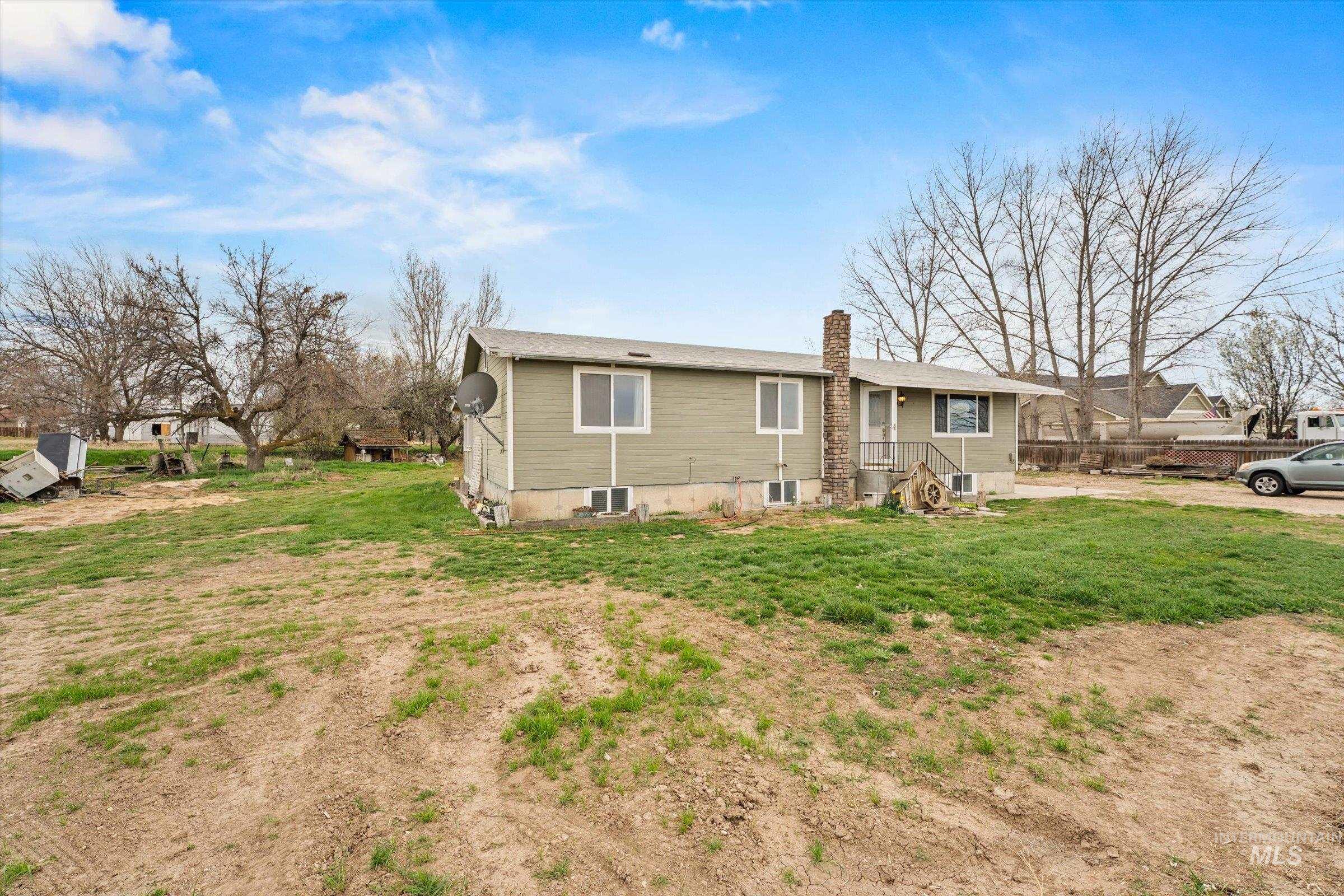 6267 Deer Flat Road Nampa, ID 83686 - Photo 5 of 50 View of front of property featuring a chimney and a front yard